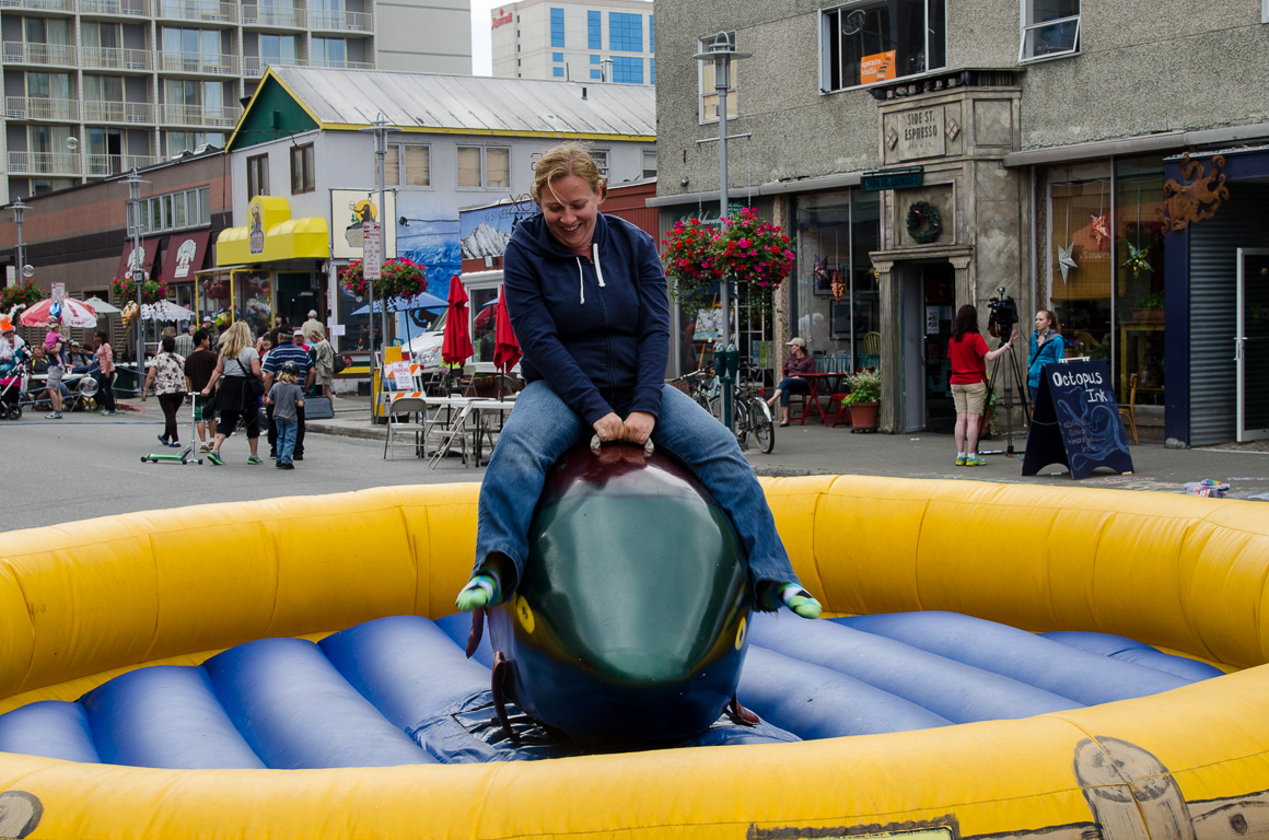 Kristy riding the mechanical dolphin