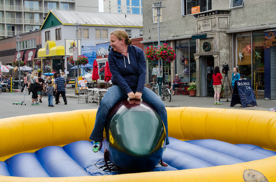 Kristy riding the mechanical dolphin