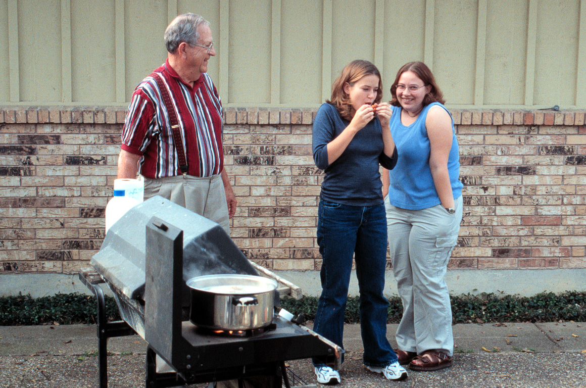 Megan & Kristy sampling the shrimp while Dad watches