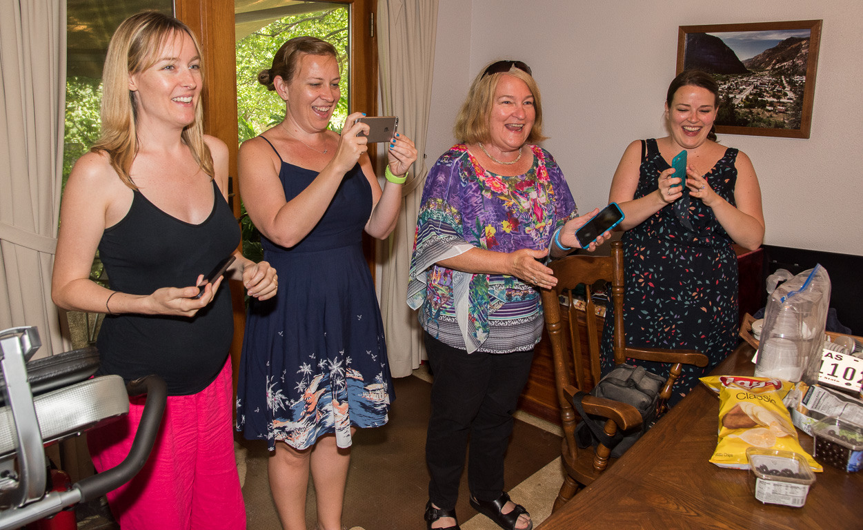 Julie, Kristy, Martha & Megan taking photos of Dad blowing out his birthday candles